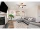 Inviting living room features a fireplace, ceiling fan, and archways offering a modern, open feel at 420 Cahors Trl, Holly Springs, NC 27540