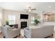 Comfortable living room with a fireplace, ceiling fan, and neutral decor at 420 Cahors Trl, Holly Springs, NC 27540
