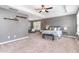 The main bedroom features a tray ceiling, carpet floor, a bright window, and a ceiling fan at 420 Cahors Trl, Holly Springs, NC 27540