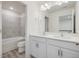 Bathroom featuring double sinks, tile, a toilet, and an open view to additional rooms at 426 Adams Pointe Ct, Angier, NC 27501