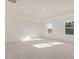 Expansive bedroom with plush carpeting, recessed lighting, and two large windows, bathed in natural light at 426 Adams Pointe Ct, Angier, NC 27501