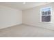Bedroom with neutral carpet and a window with a view of the house next door at 426 Adams Pointe Ct, Angier, NC 27501