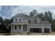 Charming two-story home featuring light blue siding, white trim, and an attached two-car garage at 426 Adams Pointe Ct, Angier, NC 27501