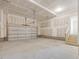 Spacious unfinished garage offers ample room for parking with stairs leading to the upper level at 426 Adams Pointe Ct, Angier, NC 27501