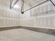 Unfinished garage with concrete floors and cinderblock foundation, offering ample storage space at 426 Adams Pointe Ct, Angier, NC 27501