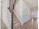 Entryway hall showcasing stairs to the upper level and two doors that lead to bedrooms or closets at 426 Adams Pointe Ct, Angier, NC 27501