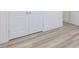 Hallway view of wood-look flooring, double door closet and doorway at 426 Adams Pointe Ct, Angier, NC 27501