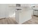 Bright kitchen with an island, stainless steel appliances, and white subway tile backsplash at 426 Adams Pointe Ct, Angier, NC 27501
