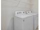 White washer and dryer sit in a white-walled laundry room with wire shelving above at 426 Adams Pointe Ct, Angier, NC 27501