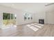 Bright and airy living room with wood floors, fireplace, large windows, and sliding doors to the outdoor patio at 426 Adams Pointe Ct, Angier, NC 27501