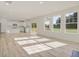 Spacious open-plan living area with lots of light, wood floors, and an adjacent kitchen in an open concept layout at 426 Adams Pointe Ct, Angier, NC 27501