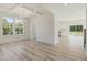 Open floorplan features wood-look flooring, lots of light, and a view into the kitchen at 426 Adams Pointe Ct, Angier, NC 27501