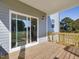Wood deck with railings, siding, and a sliding glass door that provides seamless transition to indoor living spaces at 426 Adams Pointe Ct, Angier, NC 27501