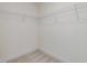 Spacious walk-in closet featuring white walls and wire shelving for optimal storage and organization at 426 Adams Pointe Ct, Angier, NC 27501