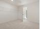 Spacious walk-in closet with carpet flooring and a white wire shelving system for organized storage at 426 Adams Pointe Ct, Angier, NC 27501