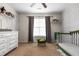 Bedroom featuring ceiling fan, large window, and a crib at 43 Summerseat Way, Bunnlevel, NC 28323