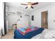 Bright bedroom with a ceiling fan, dresser, carpet flooring and decorated with shelves and toys at 43 Summerseat Way, Bunnlevel, NC 28323