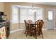 Bright dining area with a bay window, stylish lighting fixture, and comfortable seating, perfect for Gathering meals at 43 Summerseat Way, Bunnlevel, NC 28323
