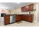 Functional kitchen with updated appliances, ample counter space, and dark wood cabinets, ideal for meal preparation at 43 Summerseat Way, Bunnlevel, NC 28323