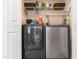 Closet laundry space with modern gray washer and dryer, and shelving for storage of supplies at 43 Summerseat Way, Bunnlevel, NC 28323
