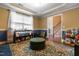 Open living space with hardwood floors, blue accent wall, a large rug and view of foyer at 43 Summerseat Way, Bunnlevel, NC 28323