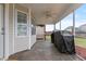 Screened-in porch with stamped concrete flooring and covered grills providing insect-free outdoor cooking at 43 Summerseat Way, Bunnlevel, NC 28323