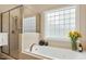 Bright bathroom with a soaking tub and a glass enclosed shower at 4313 Branchwood Dr, Durham, NC 27705
