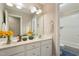 Bathroom with a double vanity, white cabinets, and a tiled tub-shower combination at 4313 Branchwood Dr, Durham, NC 27705