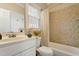 Bright bathroom with a shower-tub combo, neutral tile, and a white vanity at 4313 Branchwood Dr, Durham, NC 27705