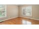 Neutral bedroom with hardwood floors and natural light from large windows at 4313 Branchwood Dr, Durham, NC 27705