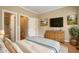 Comfortable bedroom featuring wood floors, a dresser with a TV, and a calming color scheme at 4313 Branchwood Dr, Durham, NC 27705