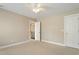 Bedroom with light carpet, ceiling fan, and a door leading to a hallway at 4313 Branchwood Dr, Durham, NC 27705