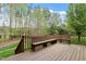 Wooden deck with built-in seating, surrounded by mature trees providing ample privacy at 4313 Branchwood Dr, Durham, NC 27705