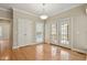 Inviting dining area with hardwood floors, double doors, and ample lighting at 4313 Branchwood Dr, Durham, NC 27705