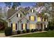 Elegant two-story home showcases traditional black shutters, a red front door, and manicured landscaping at 4313 Branchwood Dr, Durham, NC 27705