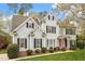 Charming two-story home with light blue siding, black shutters, manicured lawn, and vibrant red door at 4313 Branchwood Dr, Durham, NC 27705