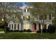 Charming two-story home boasts a manicured lawn, a bright red front door, and classic black shutters at 4313 Branchwood Dr, Durham, NC 27705