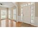 Inviting foyer with hardwood floors, classic trim, and abundant natural light from large windows at 4313 Branchwood Dr, Durham, NC 27705