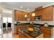 This kitchen features wooden cabinets, granite counters, stainless steel appliances, and a functional kitchen island at 4313 Branchwood Dr, Durham, NC 27705