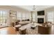 Cozy living room boasts hardwood floors, a fireplace, and is lit by ample natural light at 4313 Branchwood Dr, Durham, NC 27705