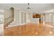 Open-concept living room with hardwood floors, staircase, and kitchen views at 4313 Branchwood Dr, Durham, NC 27705