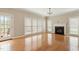 Cozy living room featuring a fireplace, hardwood floors, and multiple windows at 4313 Branchwood Dr, Durham, NC 27705
