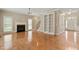 Open living room with fireplace, built-in shelving, staircase, and hardwood flooring at 4313 Branchwood Dr, Durham, NC 27705