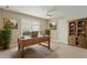 Home office with a large wood desk, bookcase, and a comfortable chair at 4313 Branchwood Dr, Durham, NC 27705