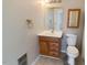 Well-lit bathroom with a single sink vanity and a toilet at 4502 Mill Creek Rd, Cedar Grove, NC 27231