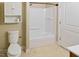 Bathroom featuring a toilet, a shower over bath and some wall shelving at 4502 Mill Creek Rd, Cedar Grove, NC 27231