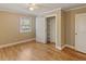 Comfortable bedroom with hardwood floors, a window, and closet storage at 4502 Mill Creek Rd, Cedar Grove, NC 27231