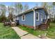 Charming one-story home with blue siding, brick foundation, and wooden porches at 4502 Mill Creek Rd, Cedar Grove, NC 27231