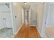 Hallway with wood and linoleum flooring leading to laundry room at 4502 Mill Creek Rd, Cedar Grove, NC 27231