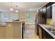 Well-equipped kitchen with dark cabinetry, and stainless steel appliances at 4502 Mill Creek Rd, Cedar Grove, NC 27231